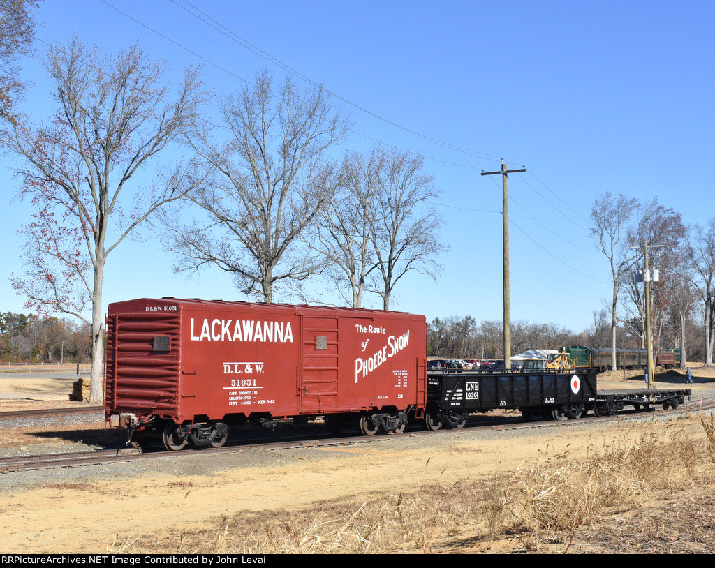 A couple of freight cars, including a Lackawanna Boxcar 